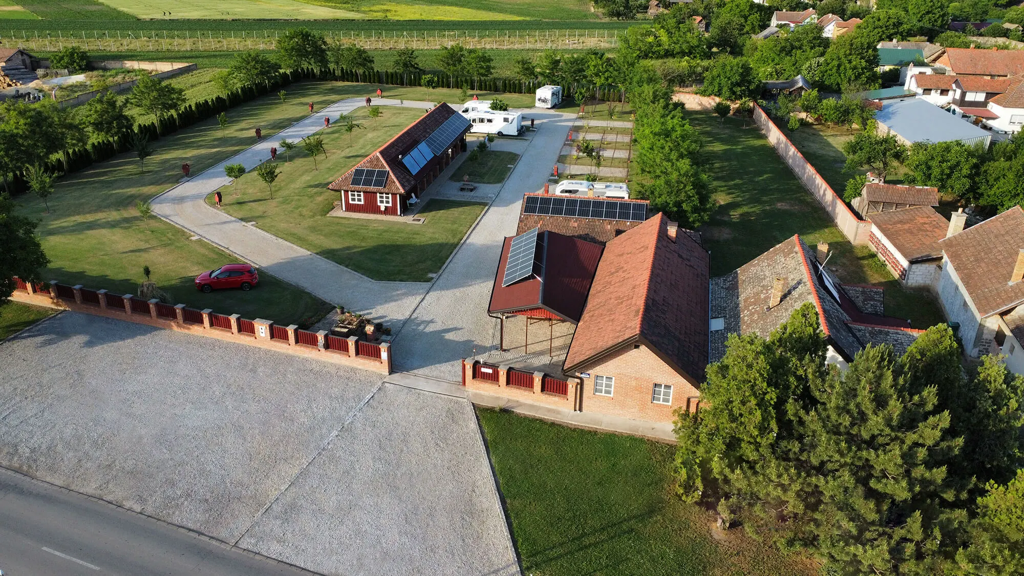 Camping Campuccino from above: the gate, the sanitary building, the pitches and the fields around the camp